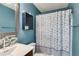 Charming bathroom with blue walls, nautical decor, and tiled mirror frame at 447 Wallace Way, Rockmart, GA 30153