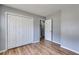 Neutral bedroom with wood-look flooring, closet, and access to an adjacent bathroom at 447 Wallace Way, Rockmart, GA 30153