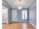 Cozy dining room area with wood-look floors, chandelier, natural light and access to kitchen at 447 Wallace Way, Rockmart, GA 30153