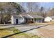 A well-maintained home with gray siding and an expansive yard offers a blend of comfort and suburban charm at 447 Wallace Way, Rockmart, GA 30153