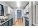 Bright kitchen features white appliances, white subway tile backsplash, and blue-gray cabinets at 447 Wallace Way, Rockmart, GA 30153