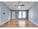 Bright living room featuring wood-look floors, a ceiling fan, and plenty of natural light at 447 Wallace Way, Rockmart, GA 30153