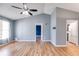 Open-concept living room with wood-look floors, ceiling fan and an attached room at 447 Wallace Way, Rockmart, GA 30153