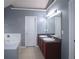 Bathroom featuring double sink vanity with dark cabinets and a large mirror with modern lighting at 3479 Lake Forge Dr, Fairburn, GA 30213
