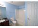 Powder blue bathroom showcasing modern toilet, shower-tub combo, large mirror, and dark vanity at 3479 Lake Forge Dr, Fairburn, GA 30213