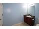 Light blue bathroom with granite vanity and large mirror at 3479 Lake Forge Dr, Fairburn, GA 30213