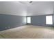 A spacious bedroom featuring neutral paint and multiple windows that provide ample natural light at 3479 Lake Forge Dr, Fairburn, GA 30213