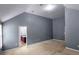 A large bedroom with vaulted ceiling, neutral colored walls and ensuite bathroom entrance at 3479 Lake Forge Dr, Fairburn, GA 30213