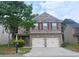 Charming two-story brick home with a two-car garage and mature trees in a well-kept community at 3479 Lake Forge Dr, Fairburn, GA 30213