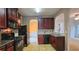 Well-appointed kitchen with dark wood cabinets, black appliances, and tile backsplash at 3479 Lake Forge Dr, Fairburn, GA 30213