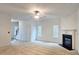 Bright living room with neutral carpet, fireplace, and windows providing ample natural light at 3479 Lake Forge Dr, Fairburn, GA 30213