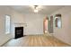 Spacious living room with a fireplace, neutral carpet, and open archways to other rooms at 3479 Lake Forge Dr, Fairburn, GA 30213