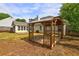 Backyard featuring a wooden pergola and view of the sun room and patio at 604 Lexington Way, Woodstock, GA 30189