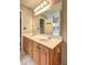 Bathroom features a double sink vanity with cabinet storage, light fixture, and large mirror at 604 Lexington Way, Woodstock, GA 30189