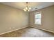 Bedroom with neutral-colored walls, carpeted floors, a window overlooking the neighborhood, and a ceiling fan at 604 Lexington Way, Woodstock, GA 30189
