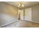 Bright bedroom featuring neutral walls, carpet floors, and a decorative chandelier at 604 Lexington Way, Woodstock, GA 30189