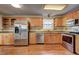 Well-lit kitchen with stainless steel appliances and plenty of counter space at 604 Lexington Way, Woodstock, GA 30189
