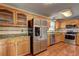 Well-equipped kitchen with stainless steel appliances and wooden cabinets at 604 Lexington Way, Woodstock, GA 30189