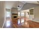 Inviting living room featuring hardwood floors, vaulted ceiling, fireplace, and an open layout at 604 Lexington Way, Woodstock, GA 30189