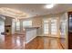 Open living room flowing from the kitchen with a stone fireplace at 604 Lexington Way, Woodstock, GA 30189