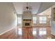 Spacious living room with beautiful hardwood floors, stone fireplace, and an open layout at 604 Lexington Way, Woodstock, GA 30189