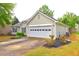Charming single-story home featuring well-maintained lawn, neat shrubbery, and convenient two-car garage at 604 Lexington Way, Woodstock, GA 30189