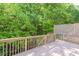 Picturesque back deck surrounded by verdant greenery, offering a serene space for relaxation and outdoor enjoyment at 902 Preserve Bluff Dr, Buford, GA 30518