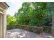 Relaxing back deck surrounded by lush greenery and trees, providing a tranquil outdoor retreat at 902 Preserve Bluff Dr, Buford, GA 30518