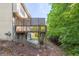 A fenced wooden deck with stairs in the backyard of the property at 902 Preserve Bluff Dr, Buford, GA 30518