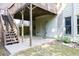 A cozy back patio beneath the wooden deck with an entrance to the basement at 902 Preserve Bluff Dr, Buford, GA 30518