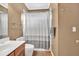 Cozy bathroom with a combined shower and tub, featuring chrome fixtures and a brown vanity at 902 Preserve Bluff Dr, Buford, GA 30518