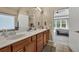 This bright bathroom features a long countertop, double sinks, and tile flooring at 902 Preserve Bluff Dr, Buford, GA 30518