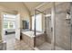 This bathroom boasts a large tub with a tiled shower and view of bedroom at 902 Preserve Bluff Dr, Buford, GA 30518