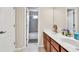 Bright bathroom with dual sinks, wood vanity, and a view of the shower and tub at 902 Preserve Bluff Dr, Buford, GA 30518