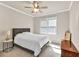 Neutral bedroom with a full bed, ceiling fan, closet, and side table at 902 Preserve Bluff Dr, Buford, GA 30518