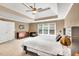 This light and airy bedroom has a large window, tray ceiling with fan, and carpet at 902 Preserve Bluff Dr, Buford, GA 30518
