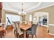 Formal dining room with a chandelier and rustic wooden table at 902 Preserve Bluff Dr, Buford, GA 30518