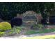 A stone community entrance with landscaping and decorative plants at 902 Preserve Bluff Dr, Buford, GA 30518