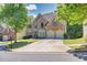 Beautiful two-story brick home with a two car garage, nice landscaping, and a driveway at 902 Preserve Bluff Dr, Buford, GA 30518