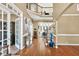 Elegant foyer featuring hardwood floors, staircase with iron railings, and views to other living spaces at 902 Preserve Bluff Dr, Buford, GA 30518