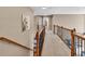 Upstairs hallway with carpet flooring, iron railings, and views to other rooms at 902 Preserve Bluff Dr, Buford, GA 30518