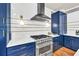 Close up of a renovated kitchen with white subway tile, blue cabinets, and stainless steel appliances at 902 Preserve Bluff Dr, Buford, GA 30518