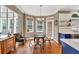 View of the eat-in kitchen with hardwood floors, blue cabinets, and adjacent living space at 902 Preserve Bluff Dr, Buford, GA 30518
