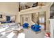 Stunning living room featuring a staircase, fireplace, and view into the modern blue kitchen at 902 Preserve Bluff Dr, Buford, GA 30518