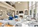 Elegant living room with large windows, fireplace, built-in shelves, and views to the upper floor at 902 Preserve Bluff Dr, Buford, GA 30518