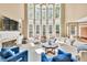Bright living room with high ceilings, a wall of windows, and cozy seating at 902 Preserve Bluff Dr, Buford, GA 30518