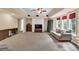 Spacious living room featuring plush carpeting, neutral walls, and abundant natural light from the bay windows at 902 Preserve Bluff Dr, Buford, GA 30518