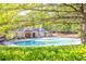 A large community pool surrounded by mature trees and comfortable lounge chairs at 902 Preserve Bluff Dr, Buford, GA 30518