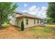 Home exterior with a well-manicured yard, featuring neat landscaping and a cozy screened-in patio at 1055 Chelsey Way, Roswell, GA 30075