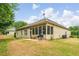 Exterior view of a house with a screened patio and a well-maintained lawn and landscaped yard at 1055 Chelsey Way, Roswell, GA 30075